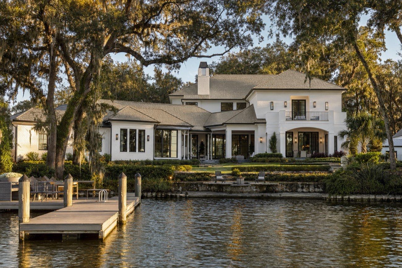 Winter Park lakefront home with a stone-gray slate-profile metal shingle roof